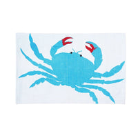 Handwoven, flat-weave coastal rug with blue crab design.