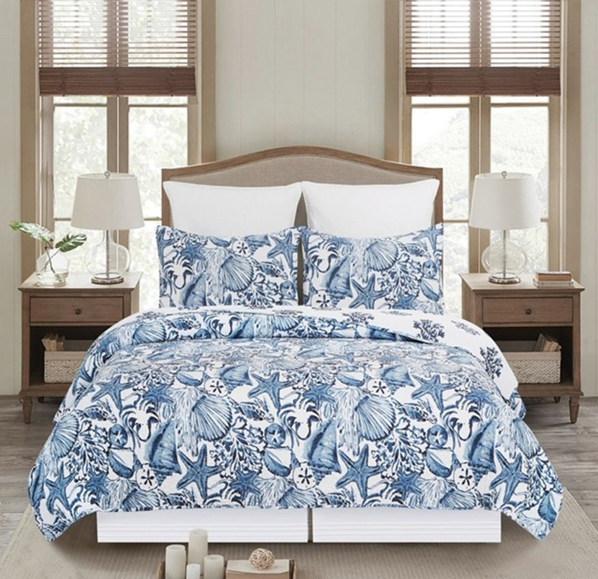 Quilt with blue shells branded coastal inspired quilt set.  Beach seashells quilt shows vibrant blues of the sea.