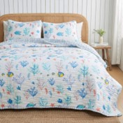A coastal seascape-designed lightweight quilt set for a bed, with a pattern of marine life including fish and coral in blue and white tones.