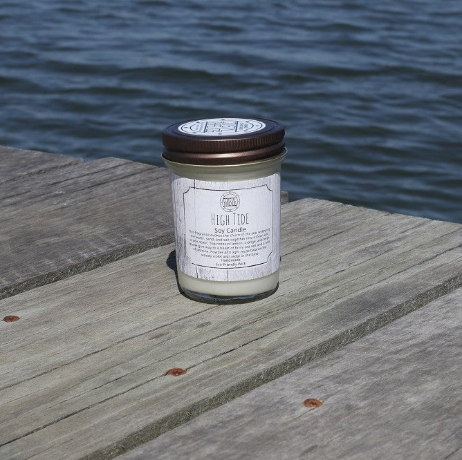 High Tide Soy Wax Candle in a jar on a dock