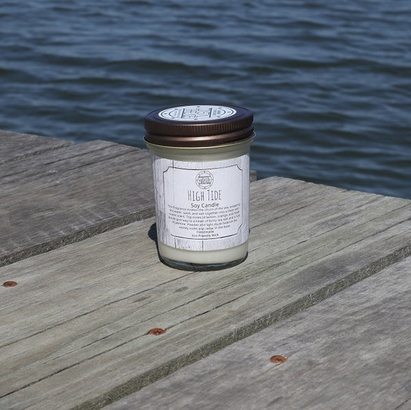 High Tide Soy Wax Candle in a jar on a dock