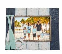 Wooden photo frame with decorative oar and life preserver flanked by nautical colors.