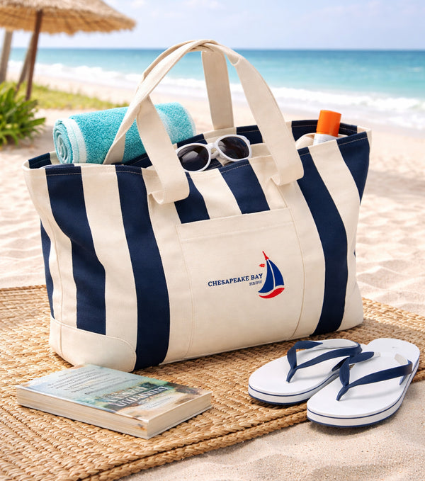 Large Navy Striped Beach Canvas Tote Beach bag with striped design, sunglasses, towel, and flip-flops on a sandy beach.