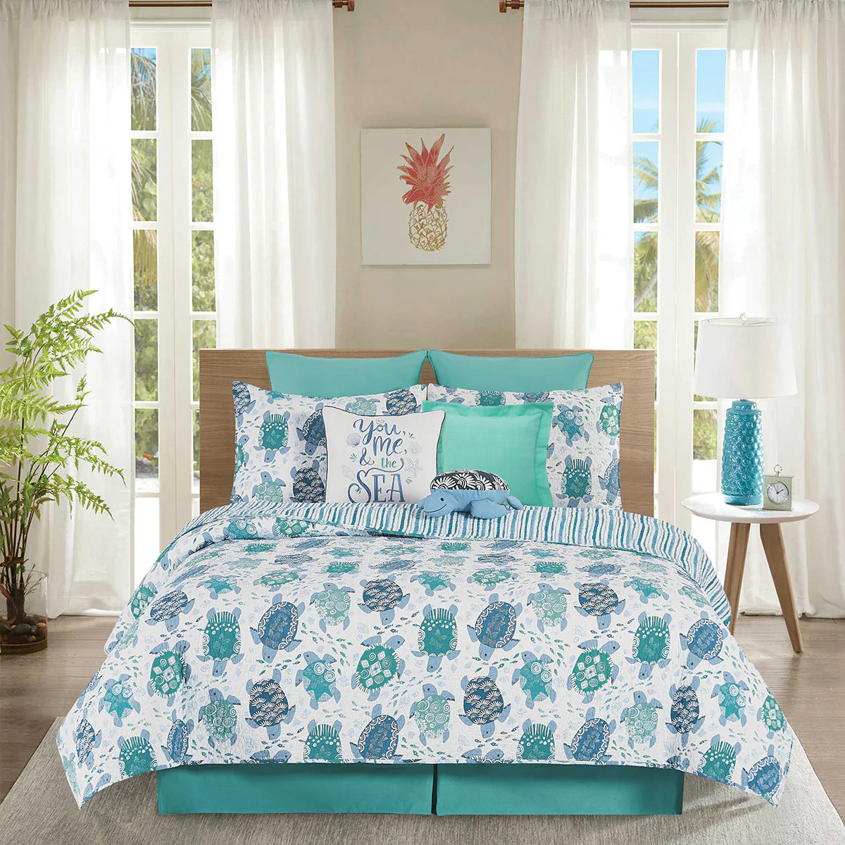 White, blue and turquoise bedding set with turtle pattern in a bedroom setting