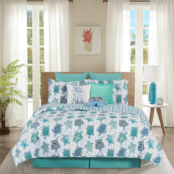 White, blue and turquoise bedding set with turtle pattern in a bedroom setting