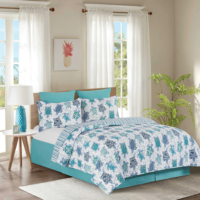 White, blue and turquoise bedding set with turtle pattern in a bedroom setting