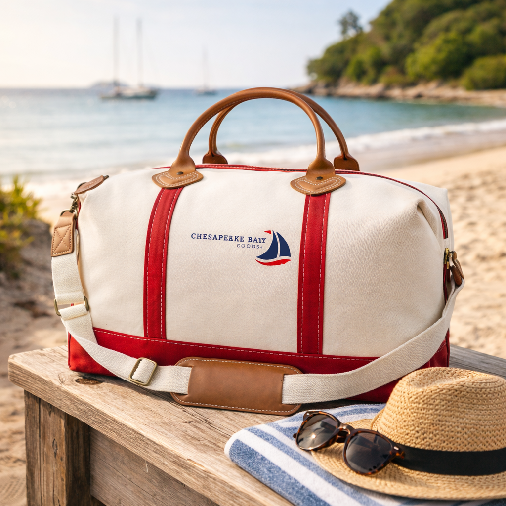 Canvas Weekender Tote with red accent, canvas shoulder strap and leather handles and insider pockets on the beach